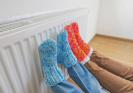 Pair of warm socks symbolizing comfort and energy savings from improved insulation provided by National Energy Grants.
