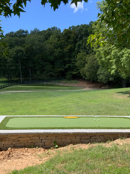 View of synthetic artificial golf putting green from 100 yards