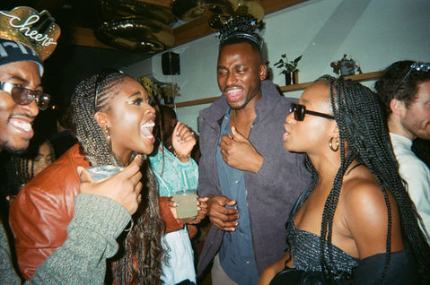 Friends celebrating New Year’s Eve at BABA in Williamsburg, Brooklyn, sharing drinks, laughter, and good vibes in a festive and intimate bar setting.