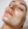 A close up of a lady with a face pack on her face