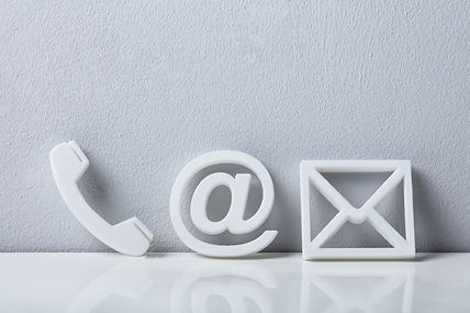 Contact Methods. Close-up Of A Phone, Email and Post Icons Leaning On White Wall.jpg