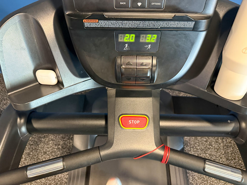 Treadmill control panel displaying speed and incline, with red "STOP" button. AirPod case and water bottle in holders.