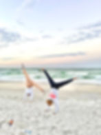 girls doing cartweel on beach