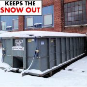 An image of a DumpsterGard keeping the snow out of a dumpster 
