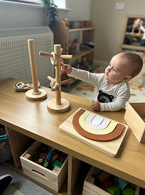 Young boy playing with wooden toys