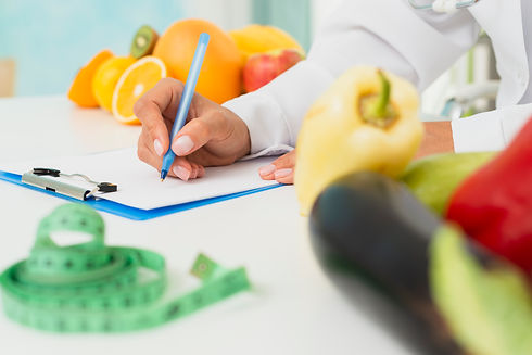 close-up-nutritionist-writing-prescripti