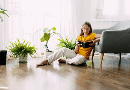attractive-girl-is-reading-book-sitting-floor-house-having-good-time.jpg