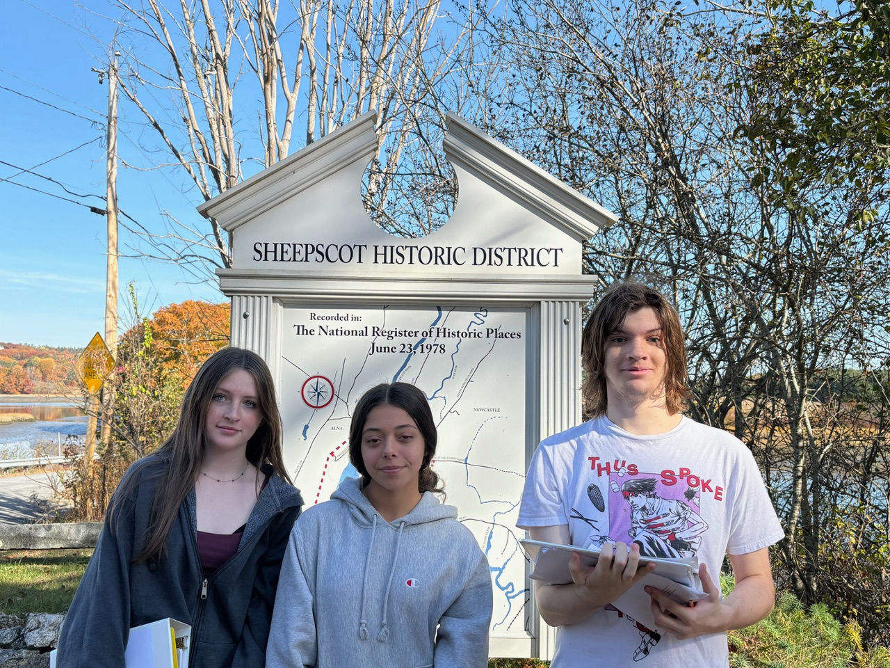 3 Students standing in front of a Sheepscot Historic District sign