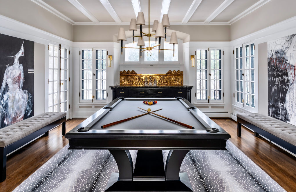 game room design with pool table and grey and white rug.