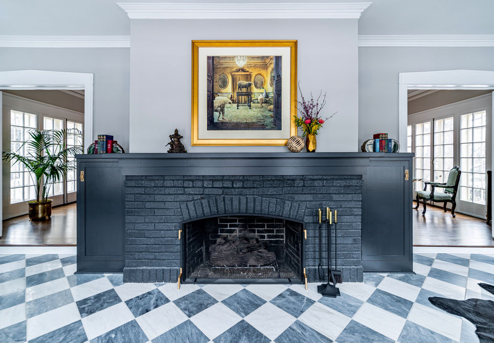 Warm living room ambiance with fireplace and saatchi art.