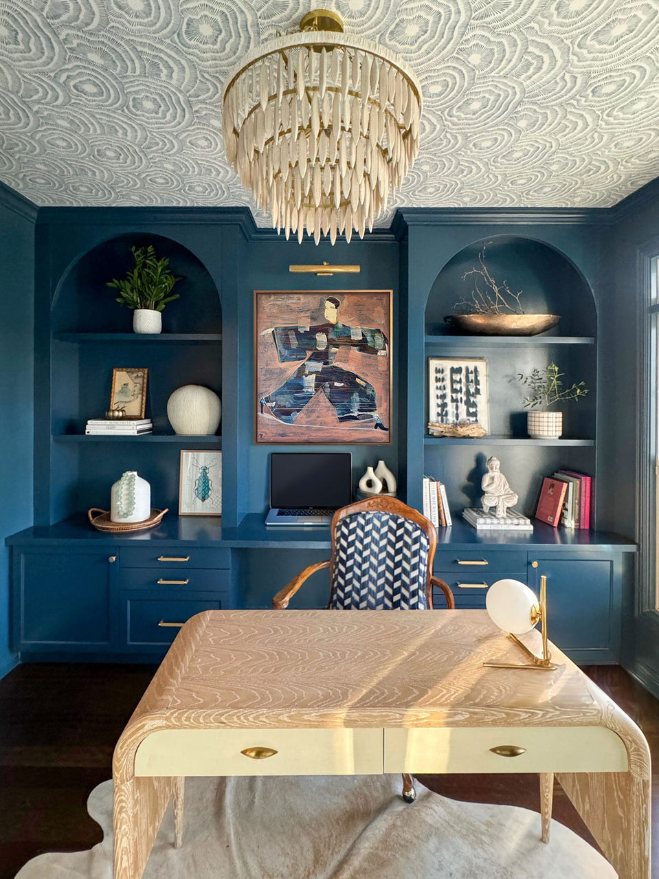 Office design with bold, modern, and chic decor with colorful, abstract art.