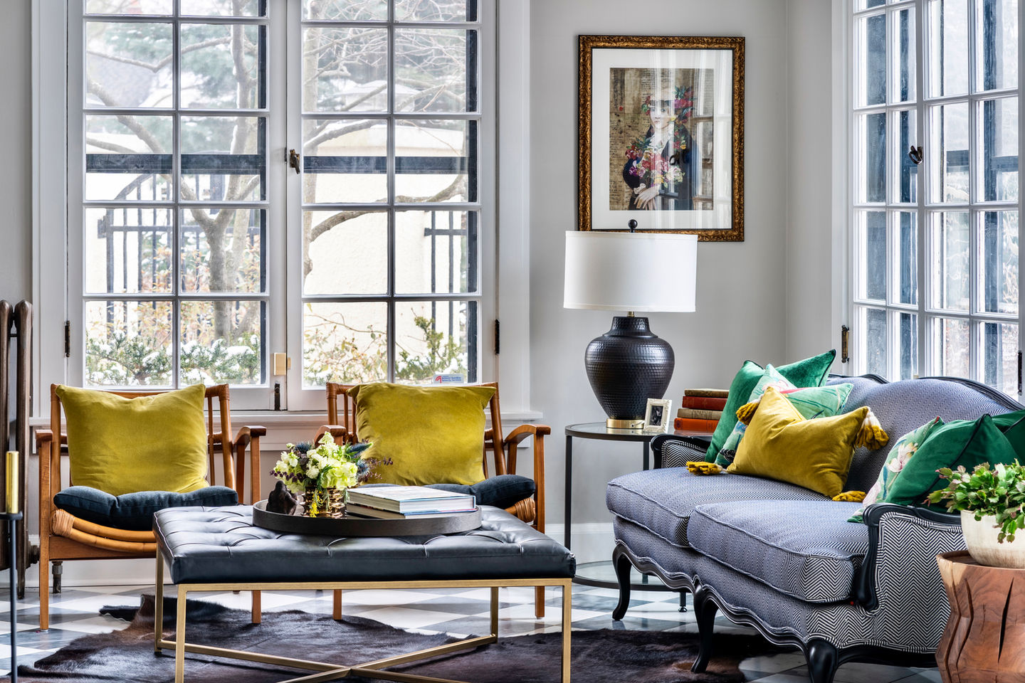 A cozy living room with pops of yellow and green decor, elegant sofa, and saatchi art.