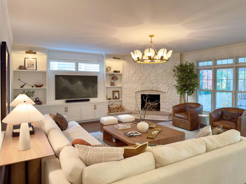 Living room interior with fireplace, plant decor, and big coffee table.