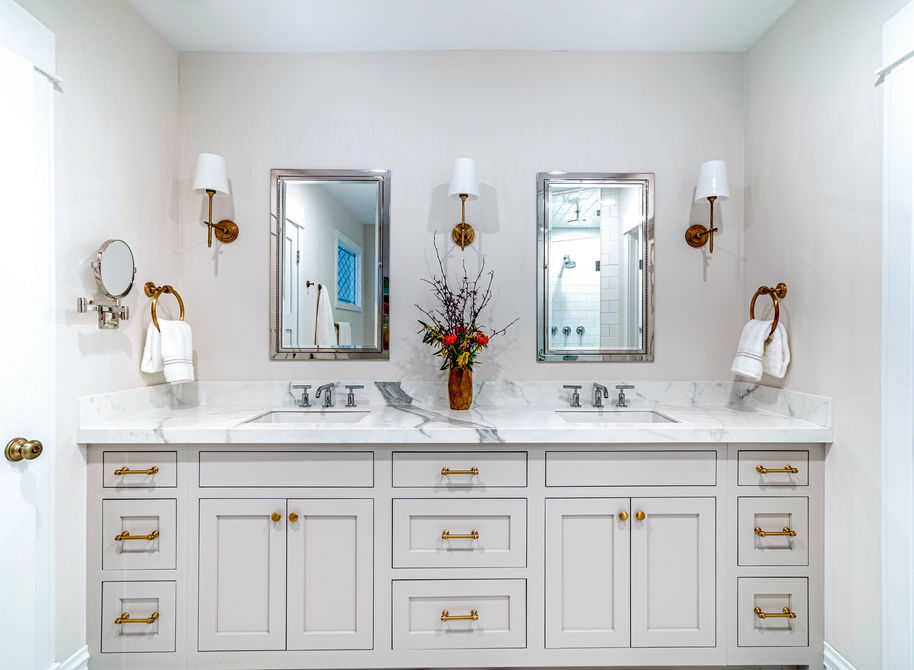 A modern bathroom design with double sinks, double mirror, and neutral color scheme.