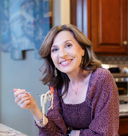 Midlife woman eating nourishing food, reflecting on health and osteoporosis awareness.