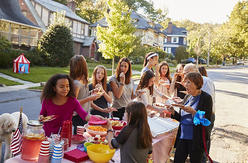 Neighbours helping themselves to food at a block party.jpg