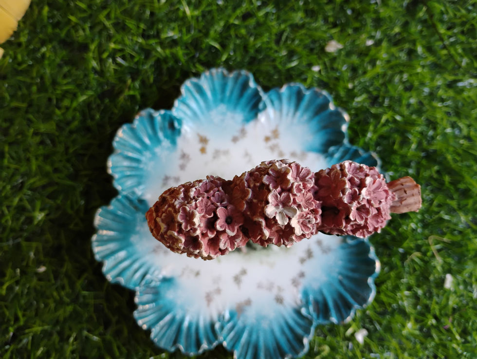 a blue and white plate with pink flowers on it