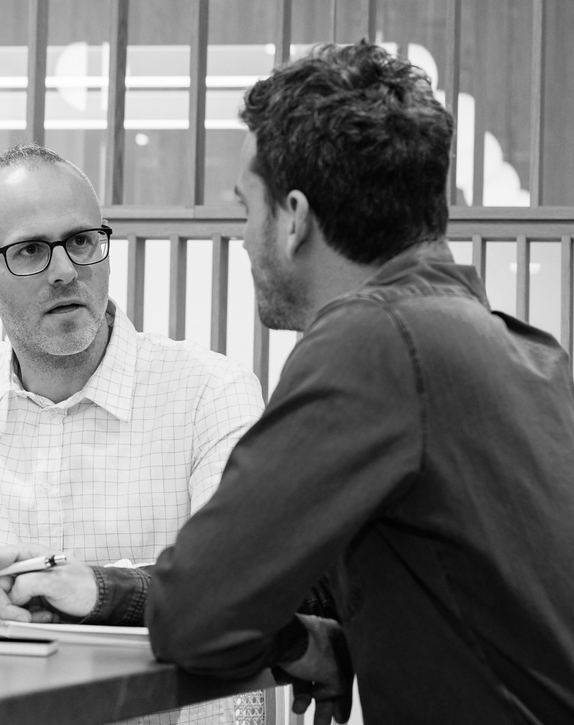 2 men in the middle of a meeting