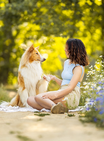ein Hund kuschelt mit seiner Besitzerin bei ihrem gemeinsamen Fotoshooting