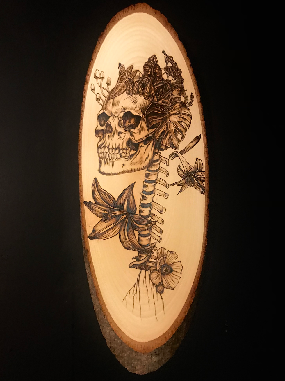 Thumbnail: Custom wood burning process of botanical skull art in Tigart Studios workspace