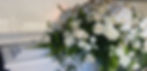 White casket with florals by funeral directors Sydney