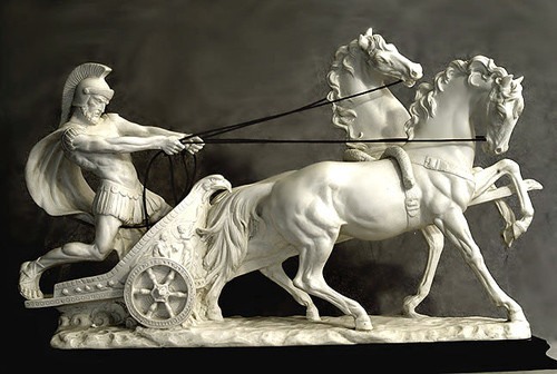 White marble statue of Gaius Appuleius Diocles most celebrated chariot racer in history- riding a duplex chariot with two horses in a bent knee position.