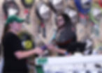 A woman asking a Racket Doctor employee for a demo racket inside of the store