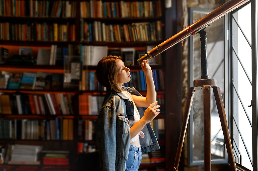 Girl looks through into telescope