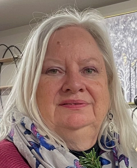 Woman with long grey hair, patterned scarf