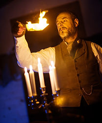 Prospero (Chris Donnelly) burning a paper boat