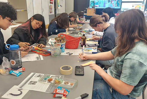 National Art Honor Society members drawing together.