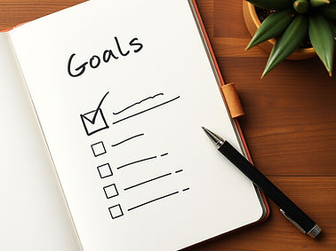 neutral colors _notebook with checkmark and pen nearby_goals plan action.jpg