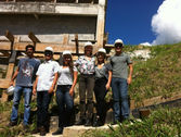 Students and teacher in front of constuction