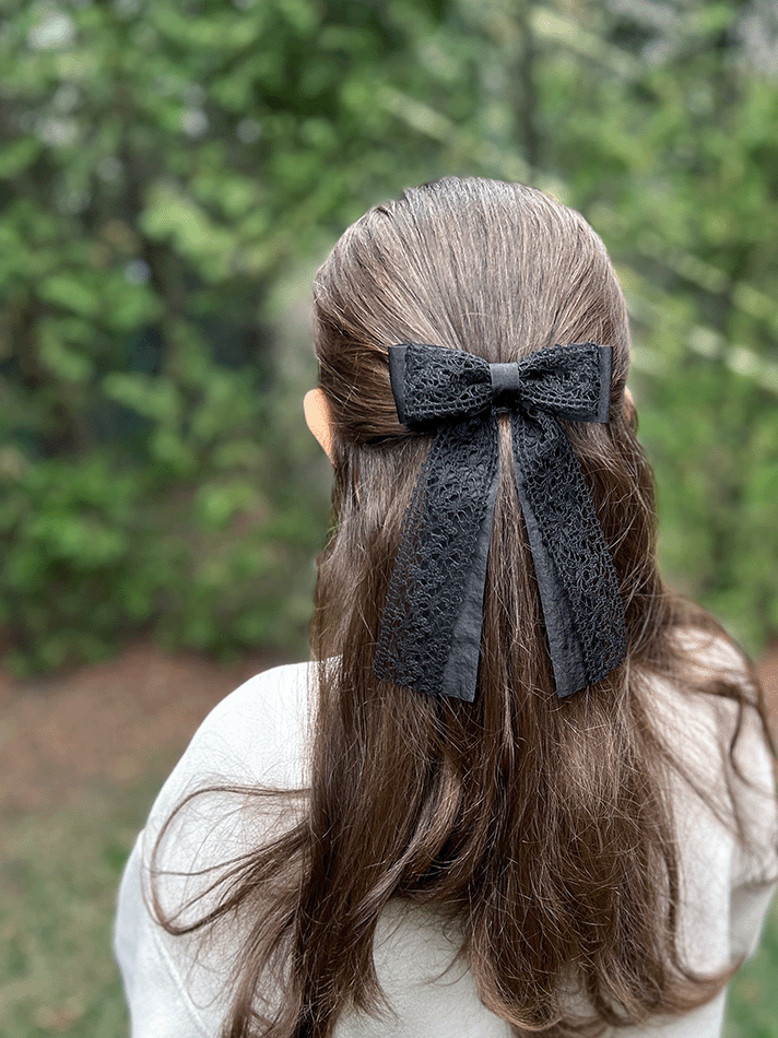 Thumbnail: Black Crochet Lace Long Tail Hair Bow, on model angled view