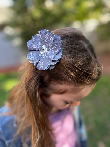 Girl wearing fabric flower hair clip