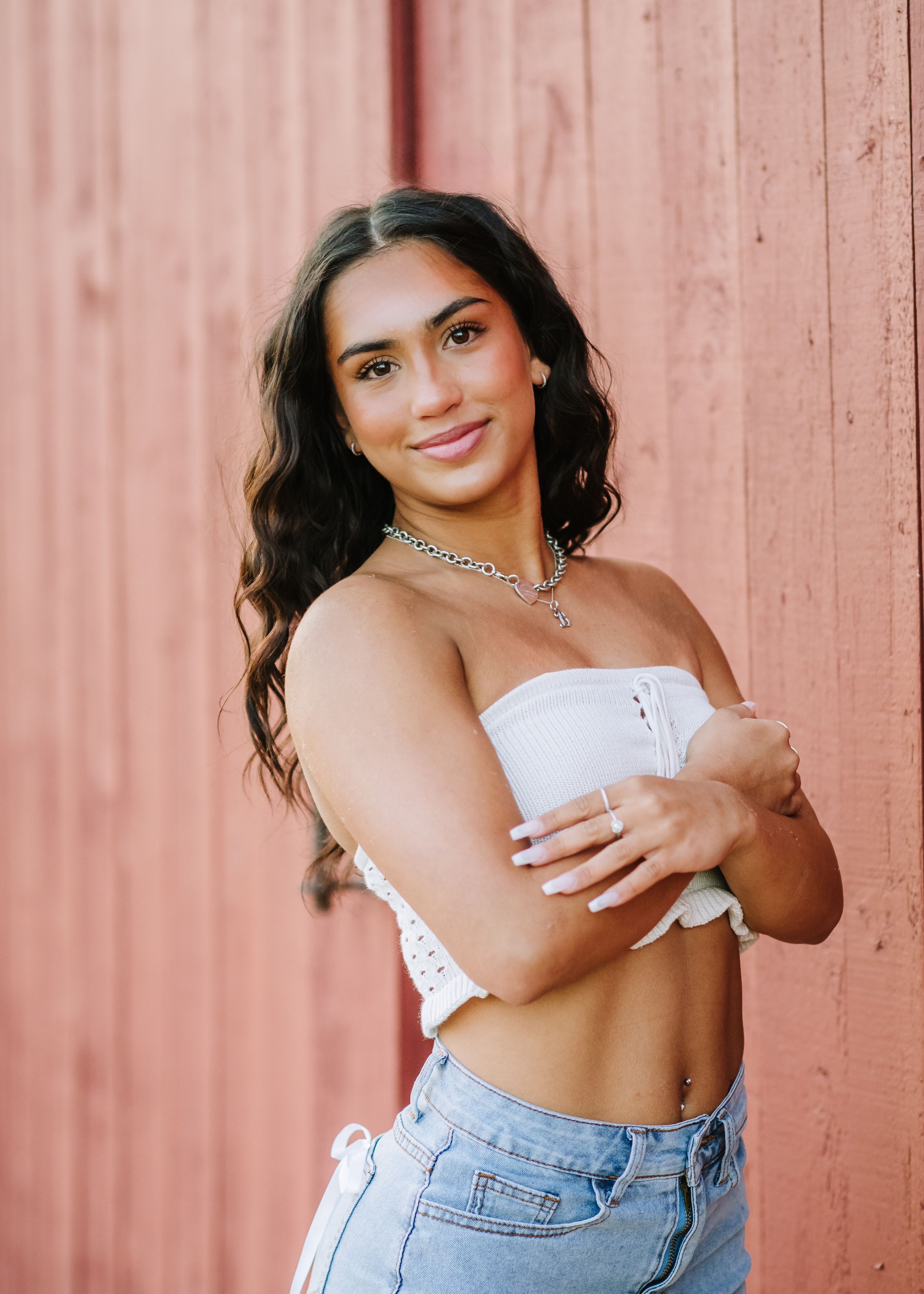 High school senior smiling during a natural-light outdoor portrait session