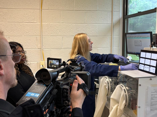 Dr Ernesta Malinauskyte from TRI demonstrating the tensile testing apparatus at one of the lab demos, and being filmed by Larry Feeley (X-Treme Scenes Productions LLC, NJ) for on-line attendees