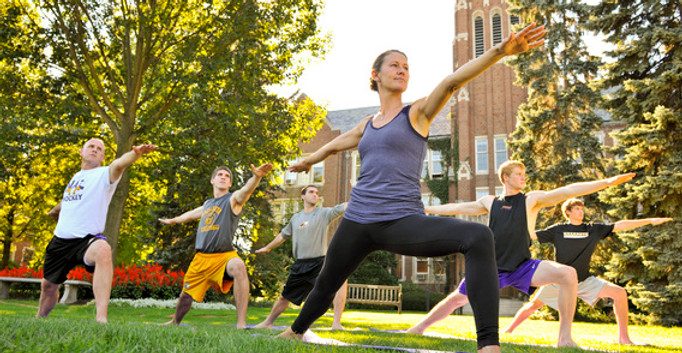 College students doing yoga