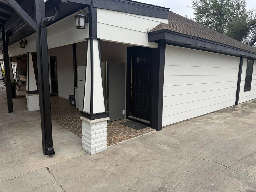 Covered front porch with craftsman columns beside a garage