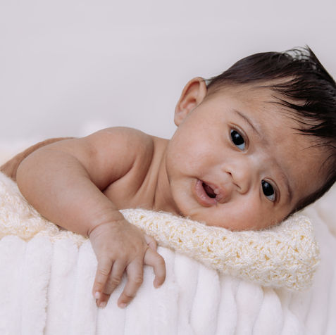 Newborn baby looking at the camera during a studio photoshoot in West Palm Beach