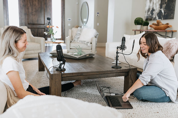Two females recording a podcast.