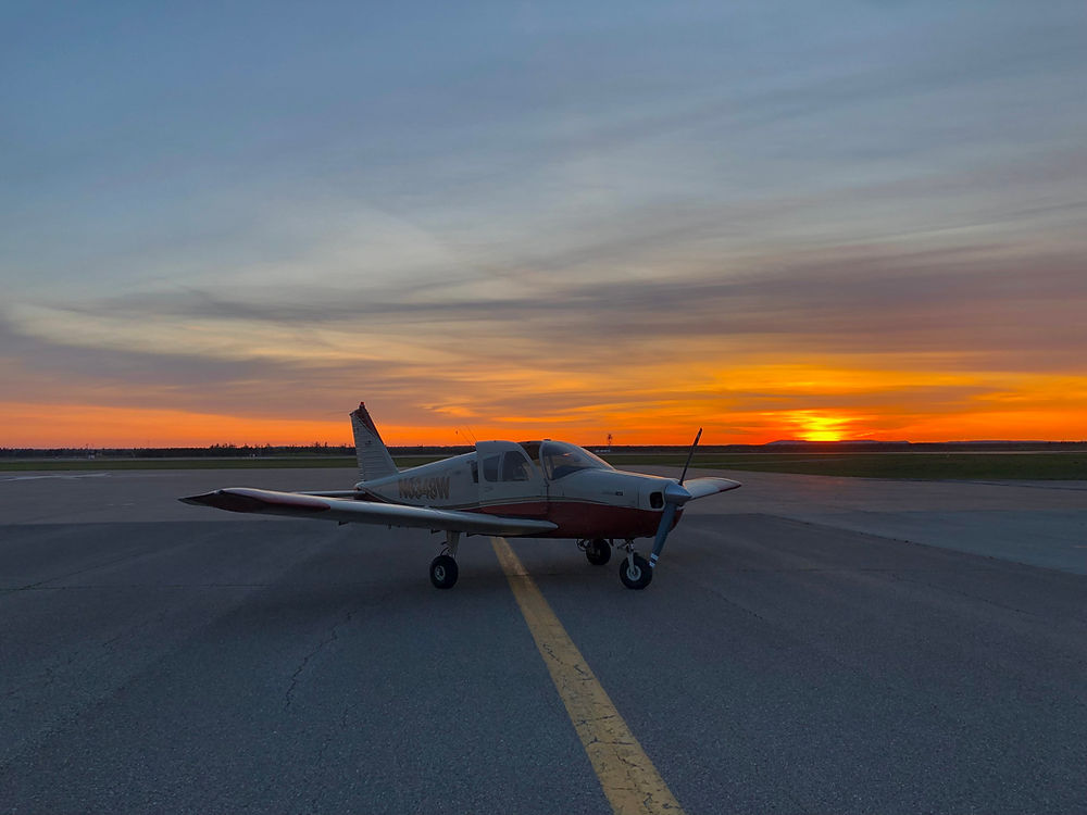 Small airplane on runway at sunset for flight training.