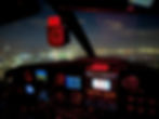 Night flight training in a cockpit over city lights