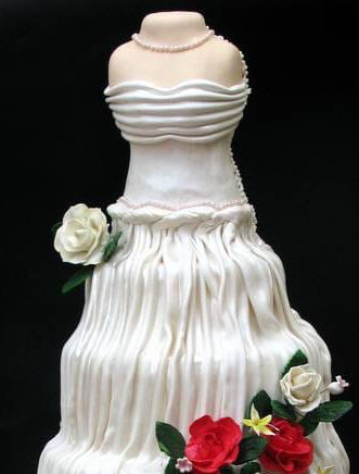 Wedding dress shaped cake with pleated fondant fabric and handmade edible red and ivory roses.