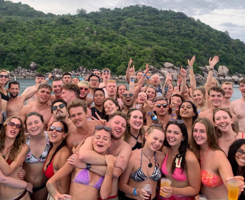 Group of people posing for camera on Koh Tao Booze Cruise top deck.
