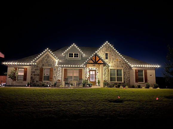 Single story house with white christmas lights