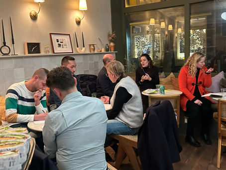 GEM Treasure Chest community members gathered around tables in a warm, inviting space, collaborating on life and career planning exercises.