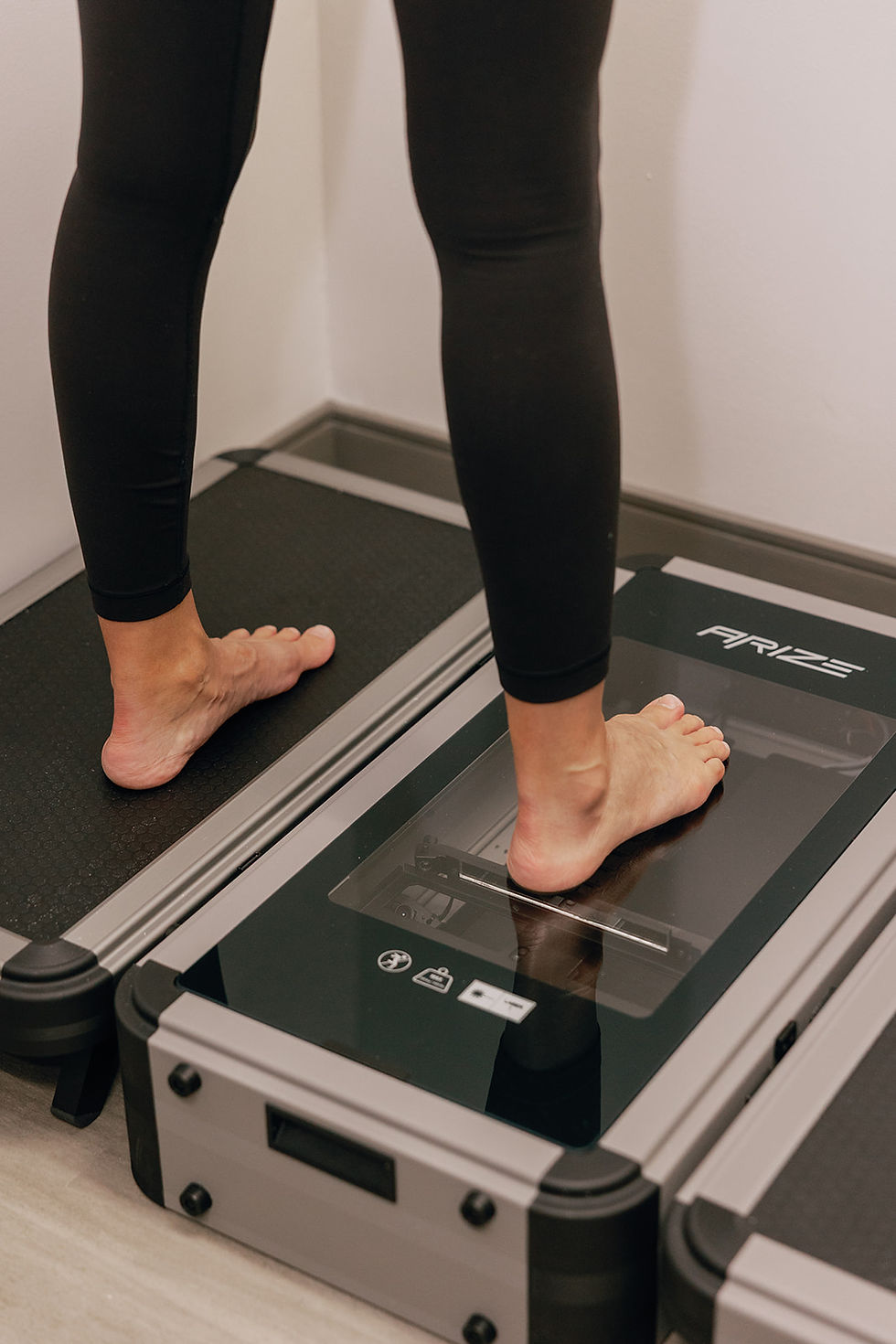 woman standing on medical device for feet