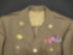 United States World War II Army uniform with service ribbons and honorable discharge insignia.