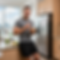 man in kitchen eating breakfast.png